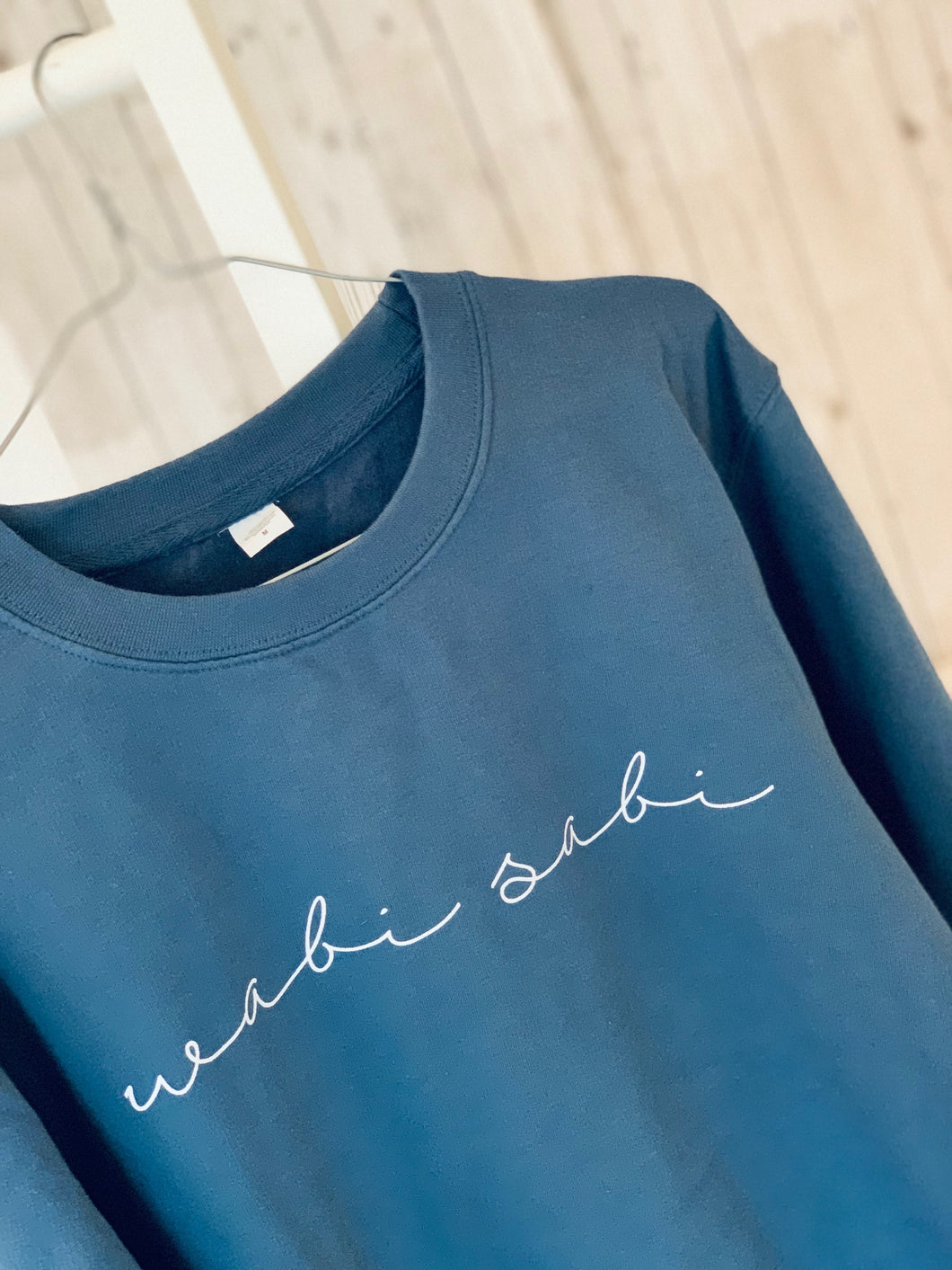 White wabi sabi on blue sweatshirt (size 12-14)