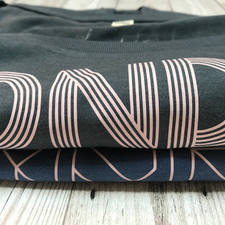 Pink SONDER on charcoal blue tee